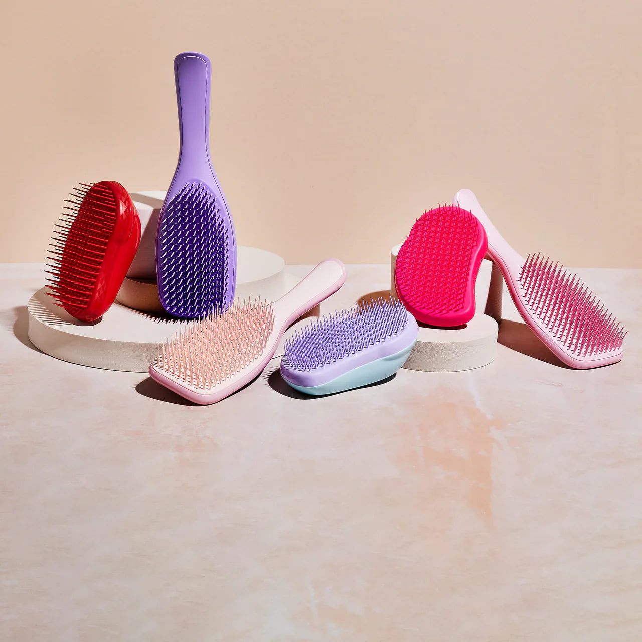 Stylish Tangle Teezer hairbrushes in various colors and designs.