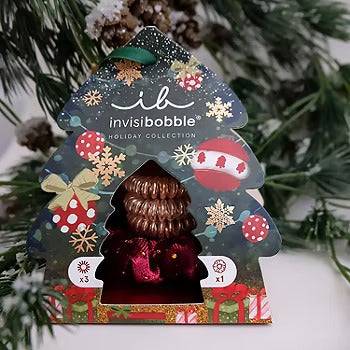 Invisibobble Holiday Set Good Things Come in Trees - 4 pieces, featuring festive gold and bronze hair rings and a sprunchie in a Christmas tree-shaped package.
