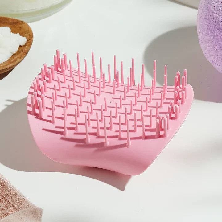 Tangle Teezer The Scalp Exfoliator and Massager in Pretty Pink, designed to gently exfoliate and stimulate the scalp for improved hair health.
