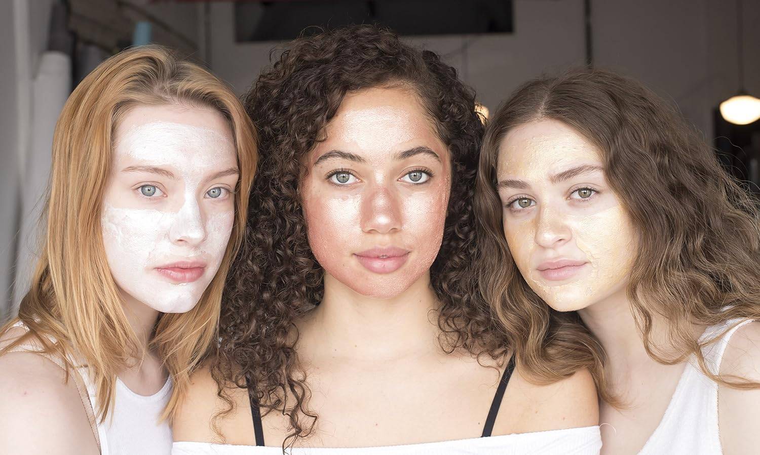 Three women with different foil peel-off masks including rose gold, showcasing skincare diversity and radiant results for all skin types.