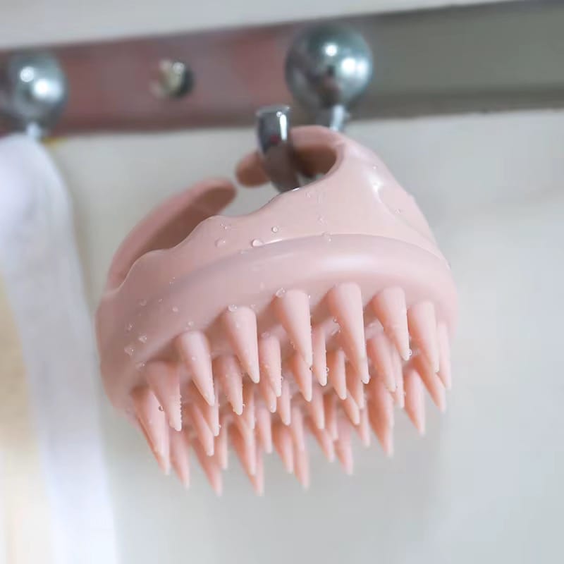 Pink Mermaid Scalp Massager hanging in shower, water-resistant design perfect for wet use. Enhances relaxation and stimulates scalp circulation.