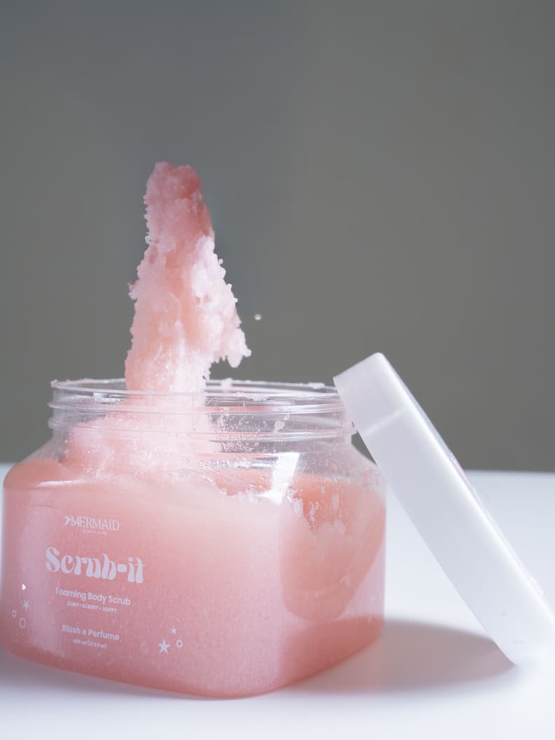 Open jar of Mermaid Foaming Body Scrub with fluffy pink texture, perfect for exfoliating and smoothing rough or dry skin.