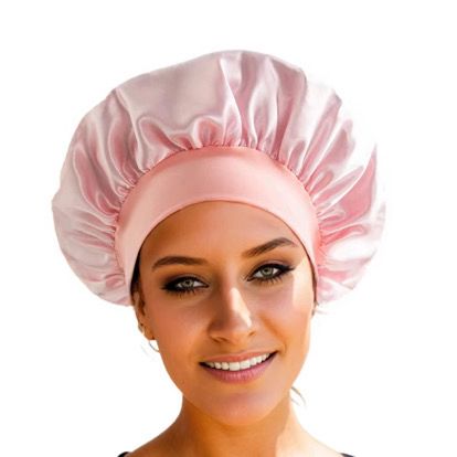 Woman wearing pink Mermaid Satin Hair Cap for Sleep, designed to retain moisture and protect hair from friction and damage overnight.