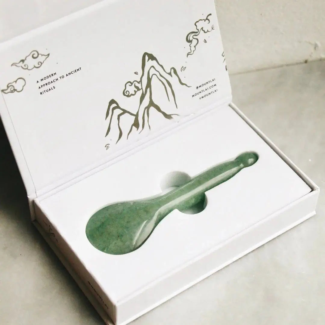 Mount Lai The Jade Acupressure Gua Sha Spoon elegantly packaged in a white box with mountain illustrations, perfect for skincare and relaxation rituals.
