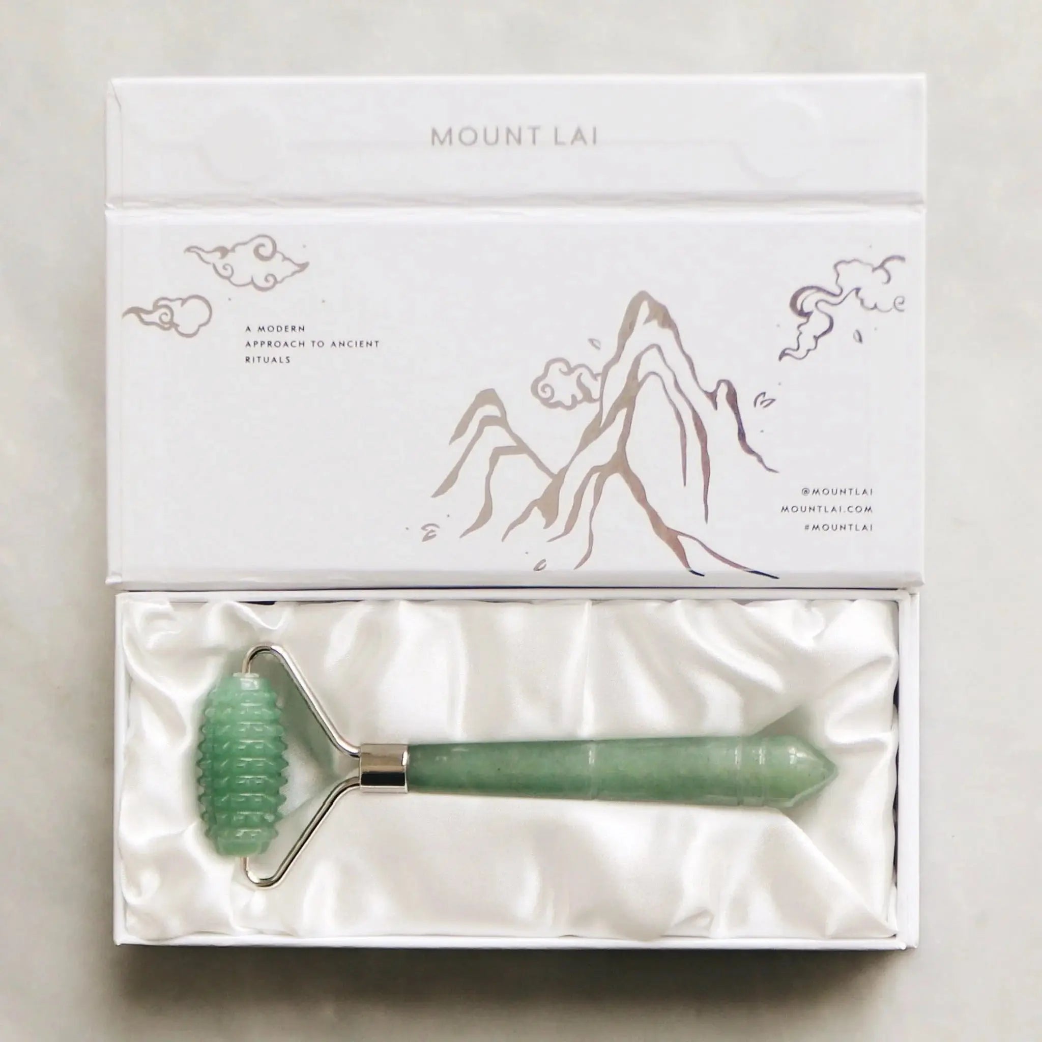Mount Lai The Jade Massage Textured Facial Roller in a satin-lined box, showcasing its premium jade material and sophisticated presentation.