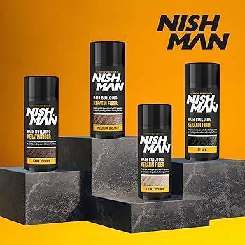 Nishman Hair Building Keratin Fibers in various shades including dark brown, displayed on stone blocks with bold branding.