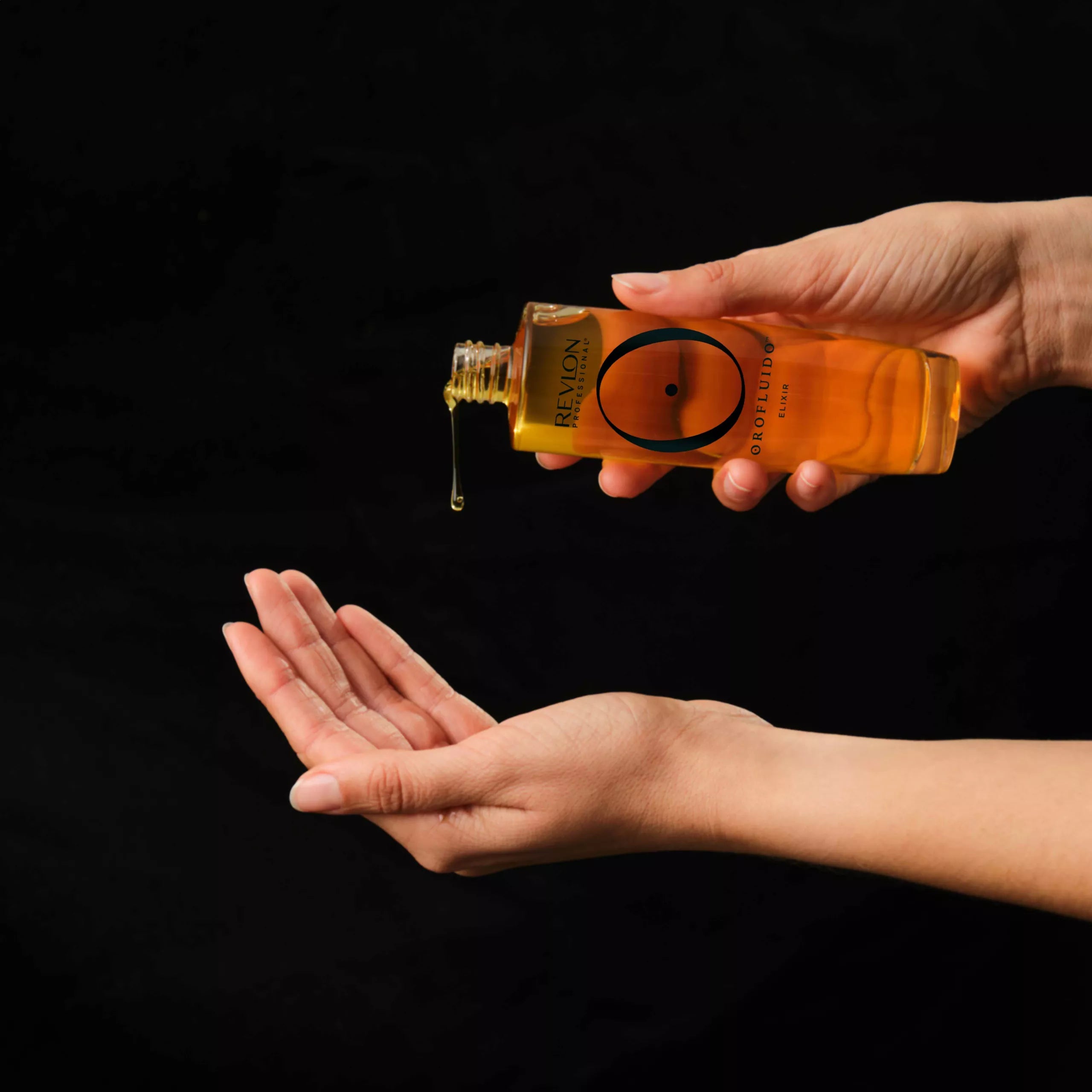 Applying Revlon Orofluido Elixir Oil to hand