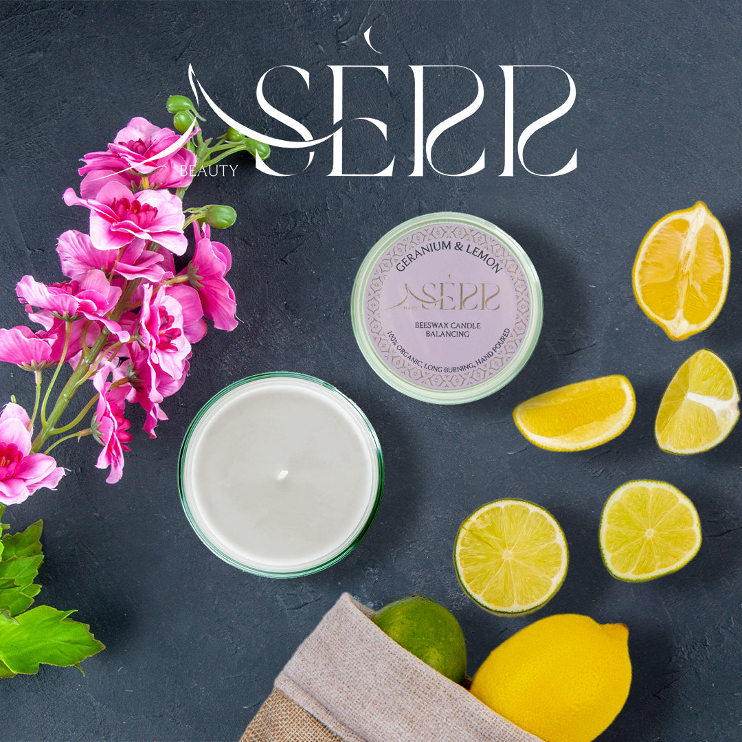 SerrBeauty Organic Geranium & Lemon Beeswax Scented Candle 125 G surrounded by fresh geranium flowers and lemon slices, highlighting its natural ingredients.