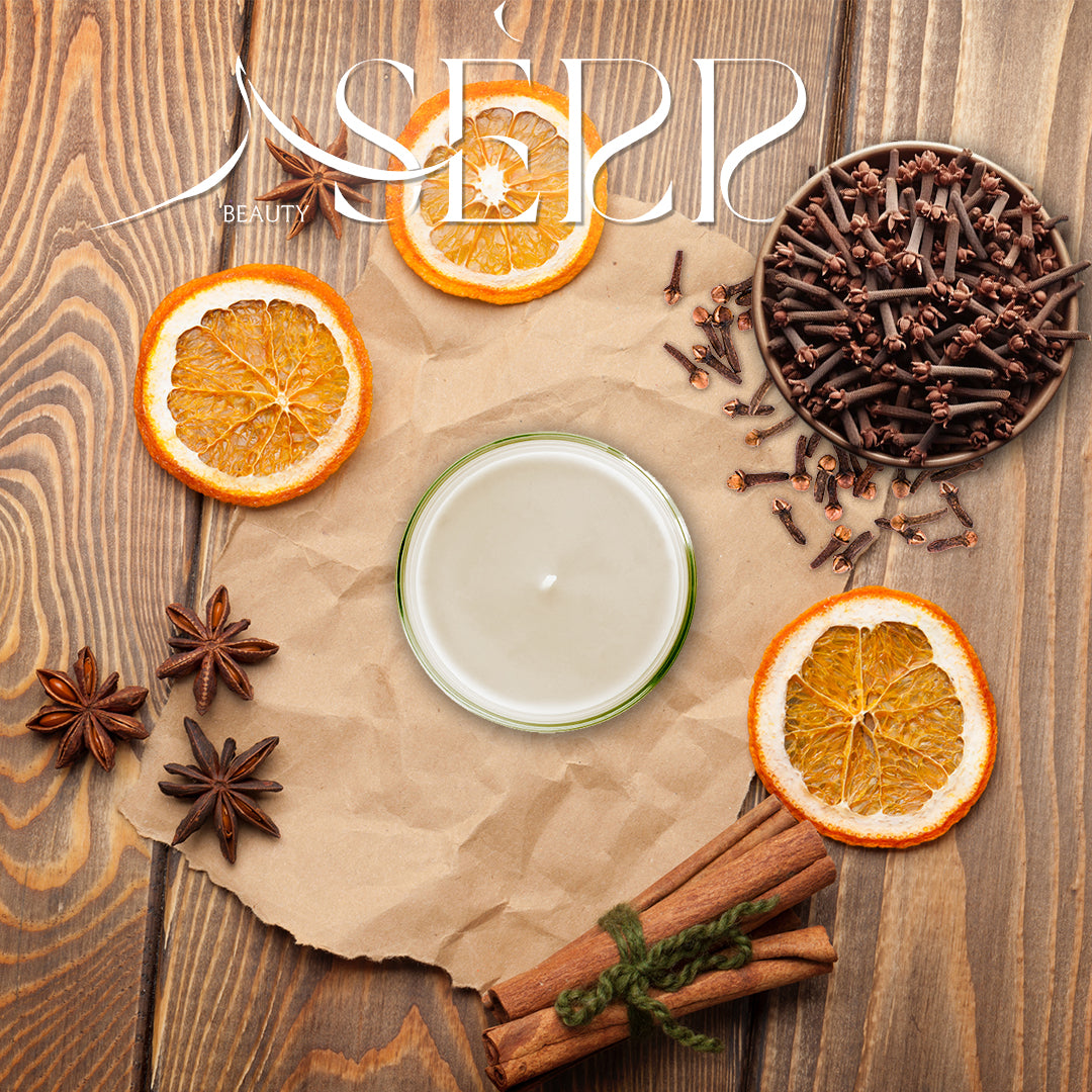SerrBeauty Organic Cinnamon, Clove & Orange Beeswax Scented Candle 125 G surrounded by dried orange slices, cinnamon sticks, cloves, and star anise. A natural, aromatic home fragrance option.