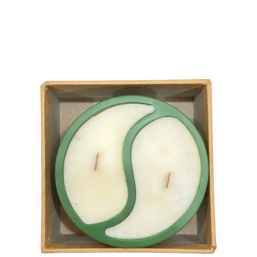 Top view of SerrBeauty Spring Whisper Candle showing yin-yang design with two scent sections and wooden wicks in a green round vessel.