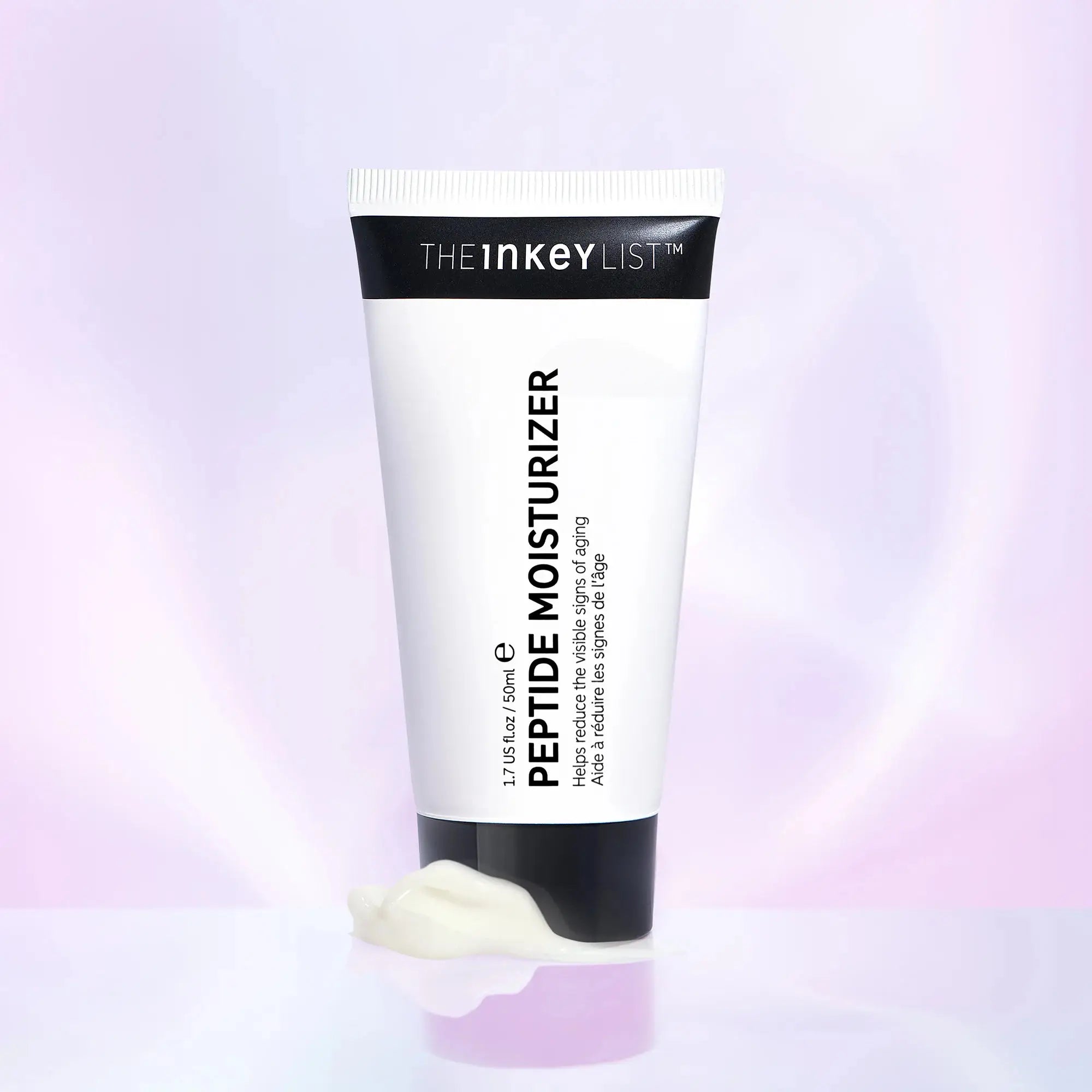 The Inkey List Peptide Moisturizer 50 ml with a smooth cream texture displayed on a reflective surface. A hydrating formula that supports skin elasticity and reduces wrinkles.