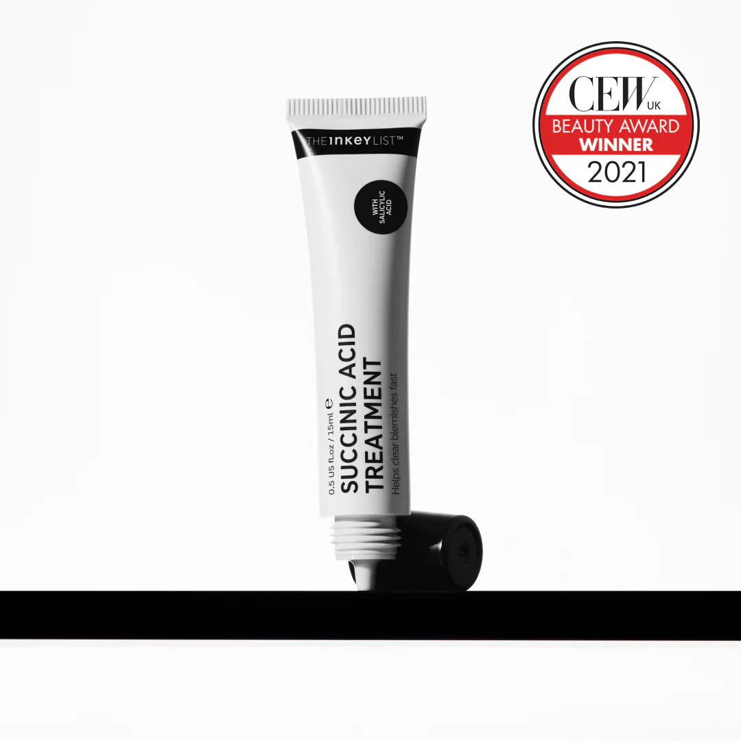 Inkey List Succinic Acid Treatment tube standing upright with CEW Beauty Award 2021 badge, highlighting its acne-fighting effectiveness.