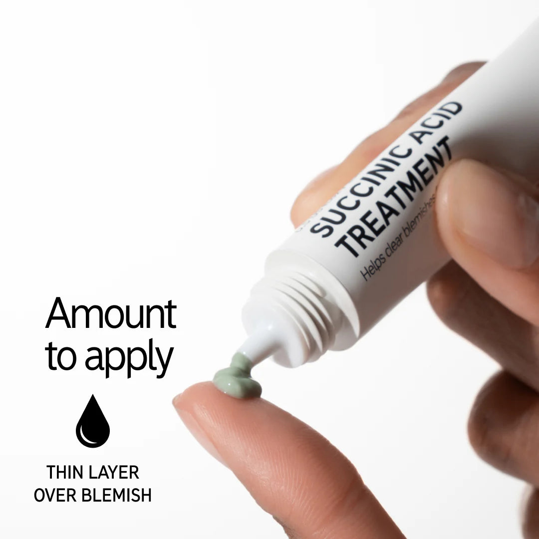 Close-up of Inkey List Succinic Acid Treatment being squeezed onto a fingertip, showing correct amount to apply over blemishes.