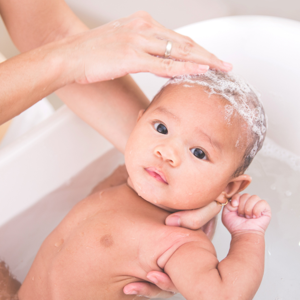 Gentle baby haircare with soothing shampoo during bath time.