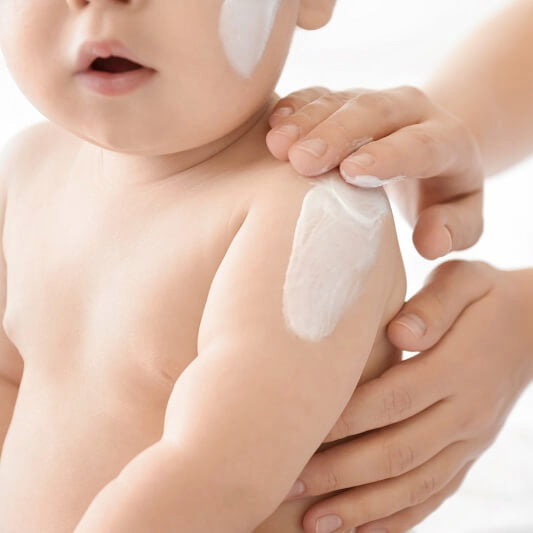 Gentle baby moisturizer applied to soft, delicate baby skin.