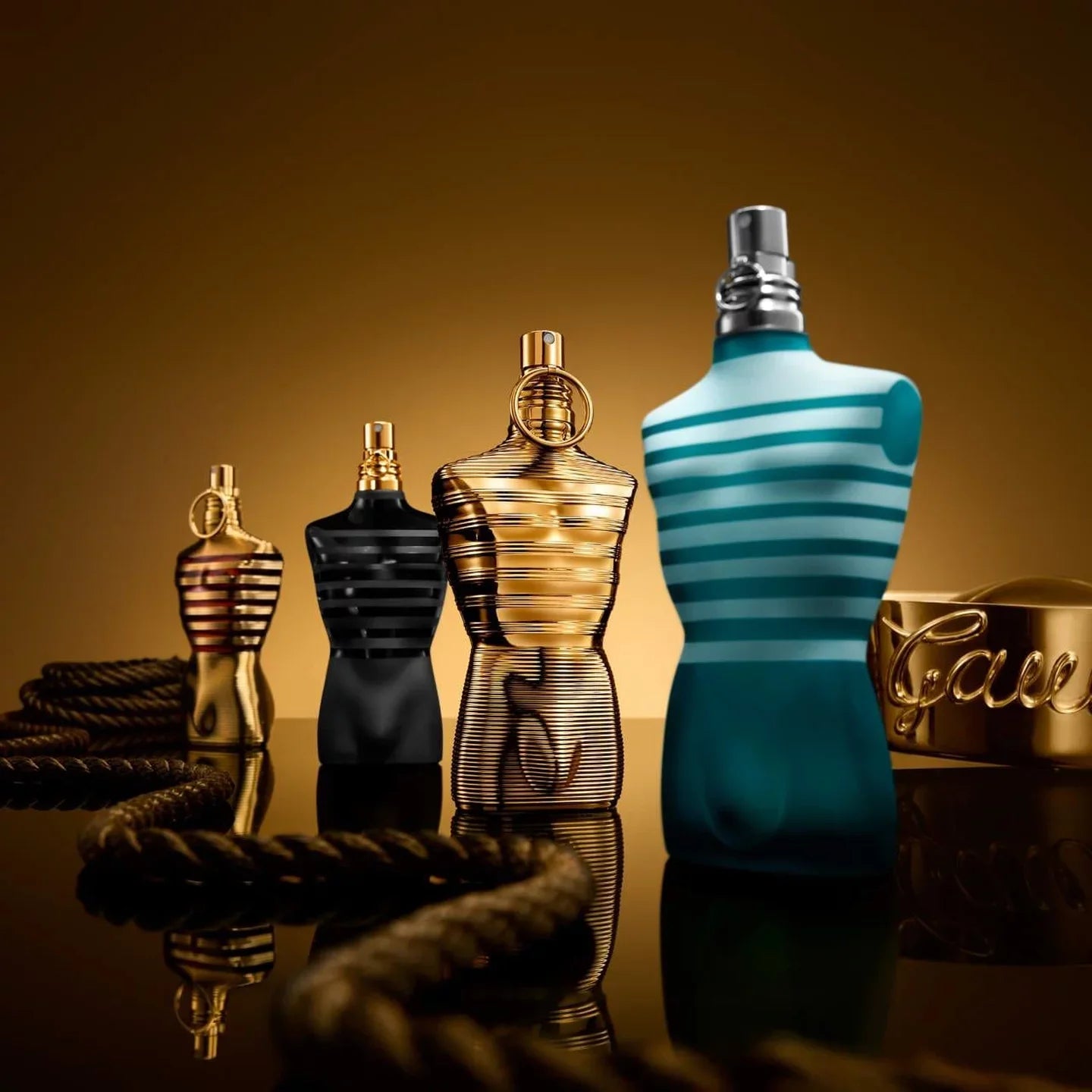 Jean Paul Gaultier Le Male perfume bottles in iconic torso shapes.