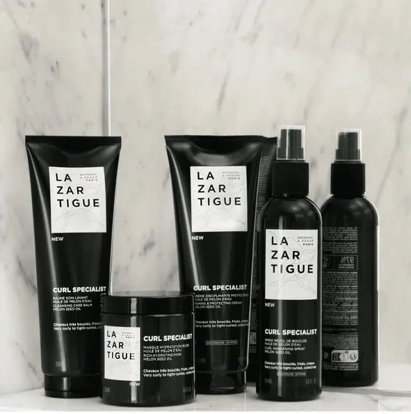 Lazartigue Curl Specialist hair care products on marble background.