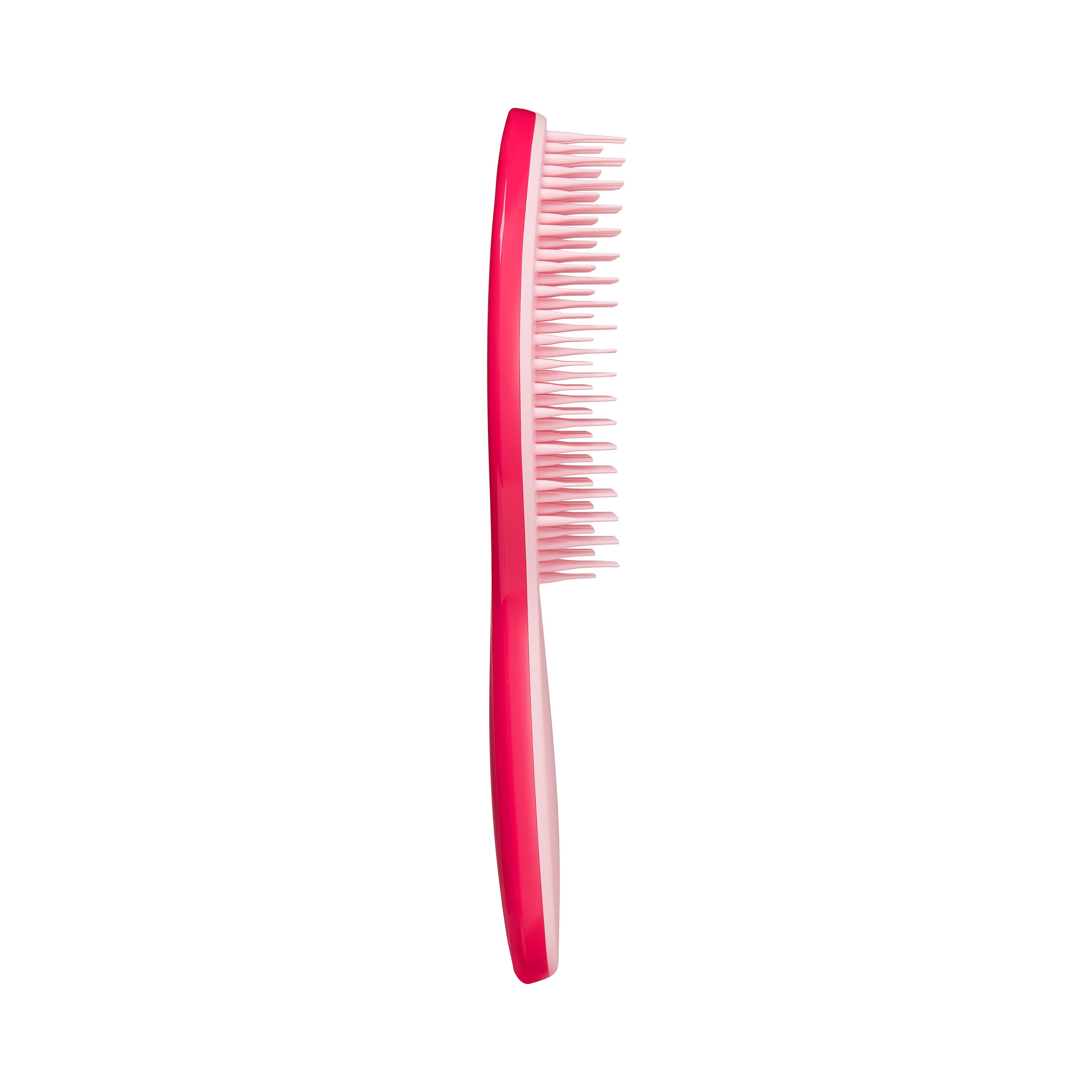 Side profile of Tangle Teezer The Ultimate Styler Bright Pink-Pink Hair Brush highlighting its curved design and flexible bristles for smooth styling.