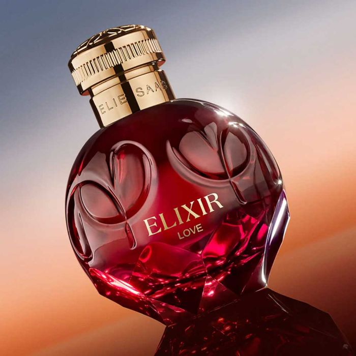 Elie Saab Elixir Love Perfume bottle displayed against a sunset background, highlighting its elegant design and romantic floral notes.
