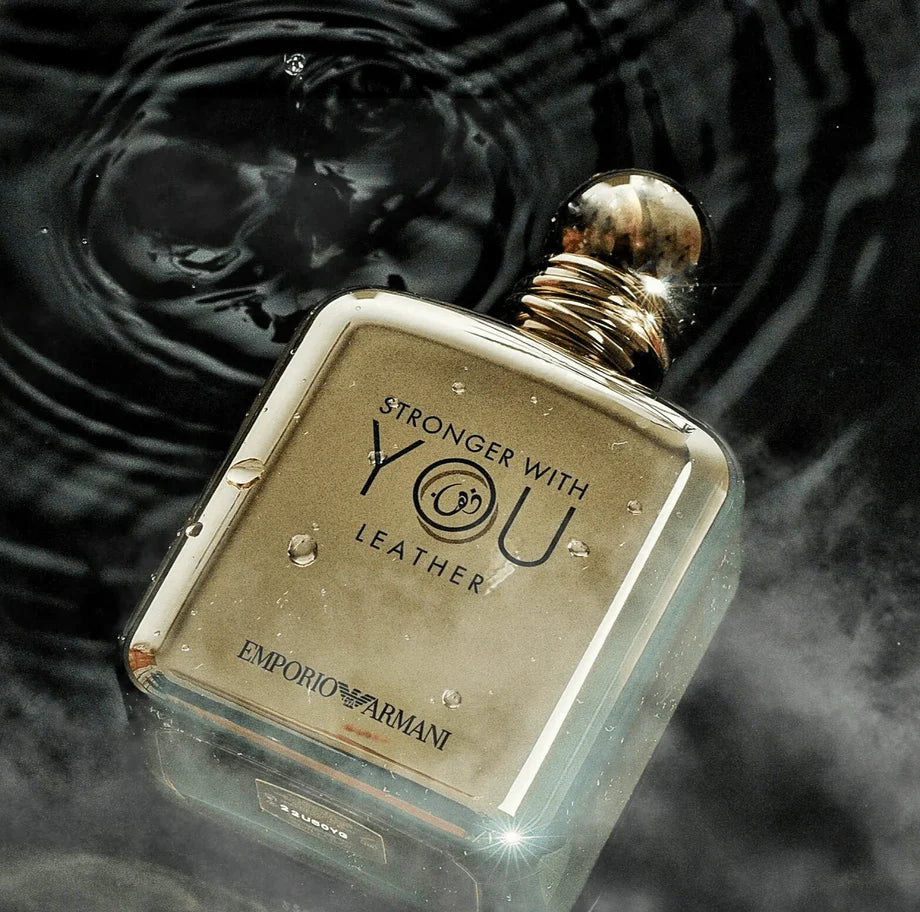Armani Stronger With You Leather EDP 100 ml gold bottle in water with mist, highlighting its intense and sensual masculine scent profile.