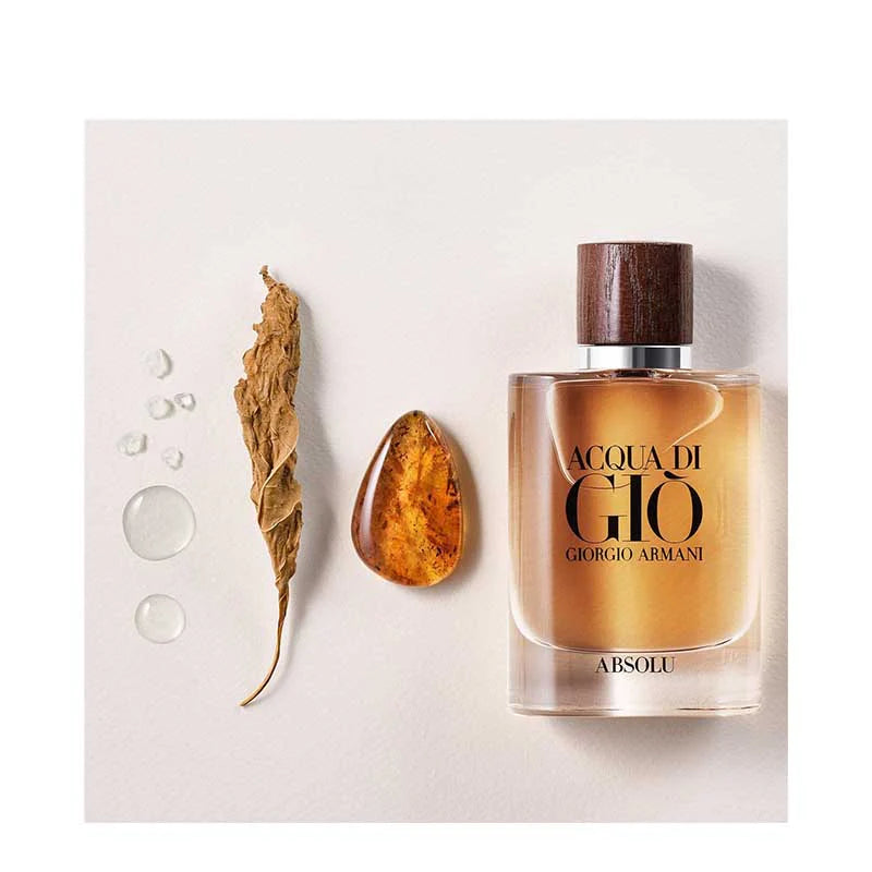 Giorgio Armani Acqua Di Gio Absolu EDP 100 ml displayed with natural elements like amber and leaves, emphasizing its aromatic fougere profile.