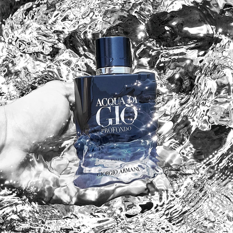 Hand holding Giorgio Armani Acqua Di Gio Profondo EDP bottle over water, emphasizing its aquatic and fresh fragrance notes.