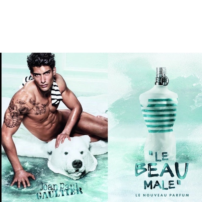 Jean Paul Gaultier Le Beau Male 125ml EDT ad featuring model and iconic striped bottle, promoting seductive Aromatic Fougere fragrance for men.