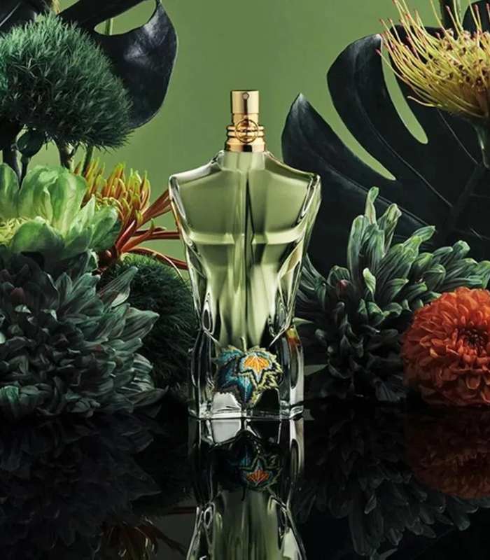 Jean Paul Gaultier Le Beau Paradise Garden EDP 125 ml displayed among lush tropical flowers, highlighting its exotic and green fragrance profile.