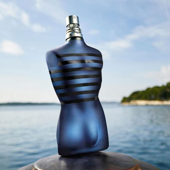 Jean Paul Gaultier Ultra Male EDT 125ml bottle displayed outdoors by the sea, showcasing its iconic torso design and masculine scent appeal.