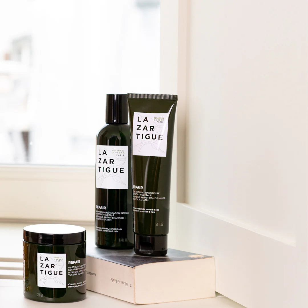 Lazartigue Repair hair care set including conditioner, shampoo, and mask, designed for damaged hair with plant-based keratin formula.