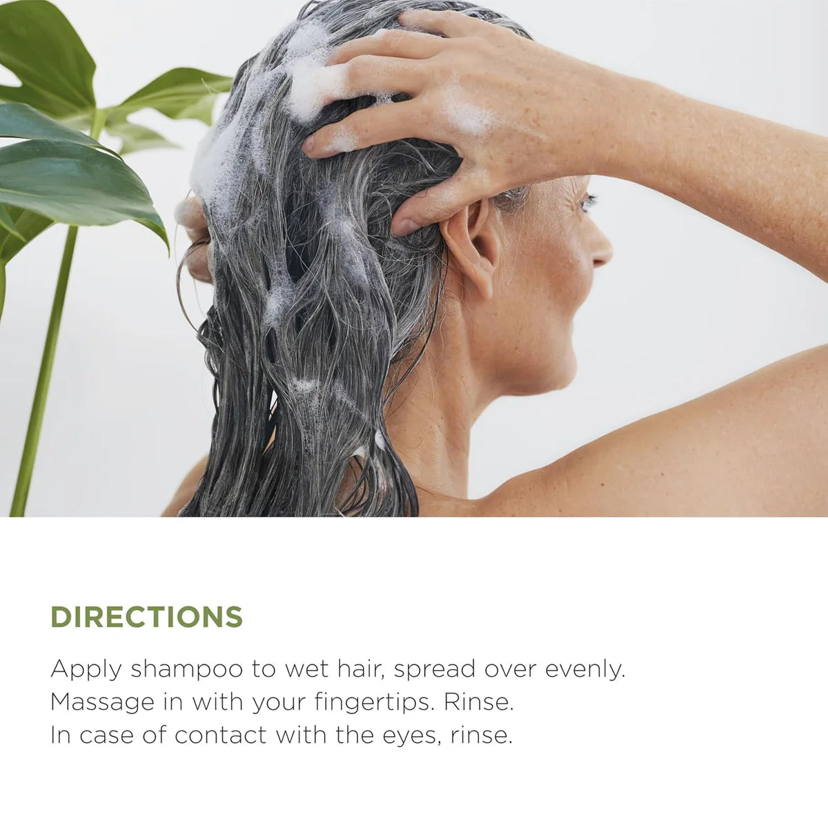 Woman applying Lazartigue Repair Shampoo 250 ml to wet hair, demonstrating usage directions for effective damaged hair repair and hydration.
