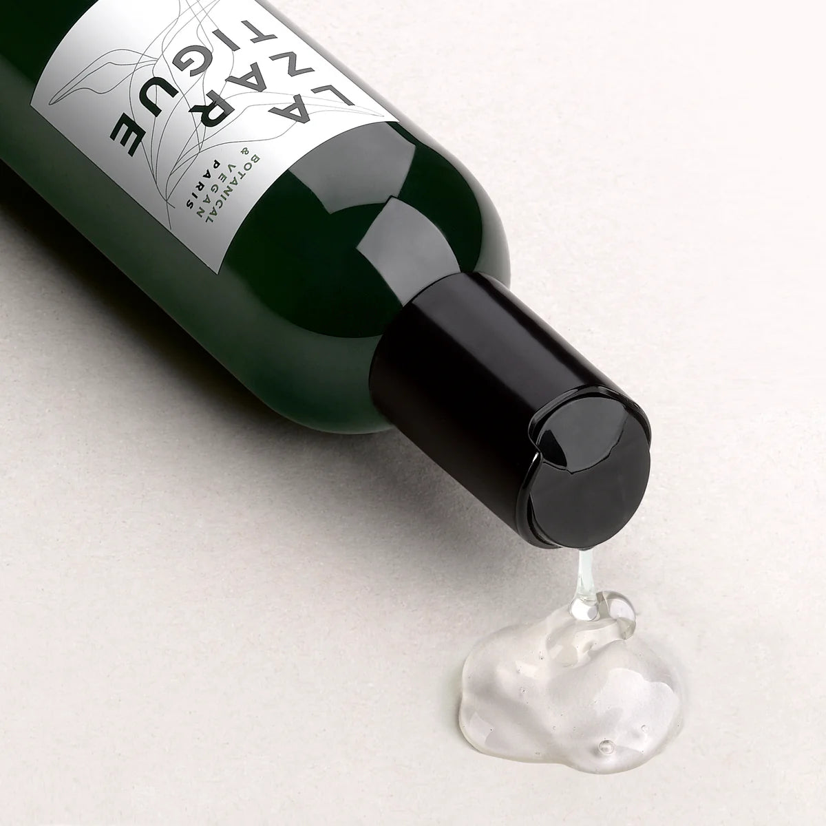 Close-up of Lazartigue Volumize Shampoo texture, showcasing its lightweight, clear formula enriched with rice protein and free from silicones.
