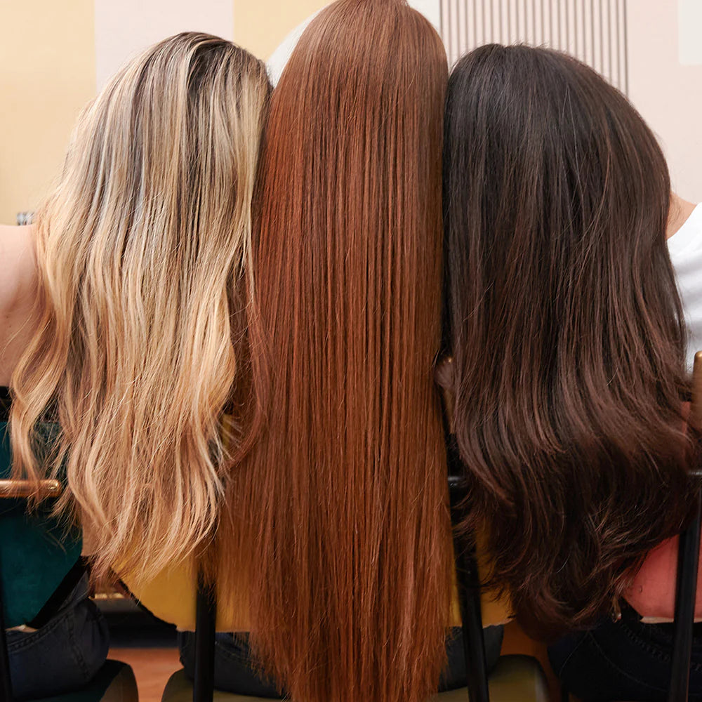 Three women with different hair colors showing sleek, frizz-free results after using Lazartigue Hair Serum for all hair types.