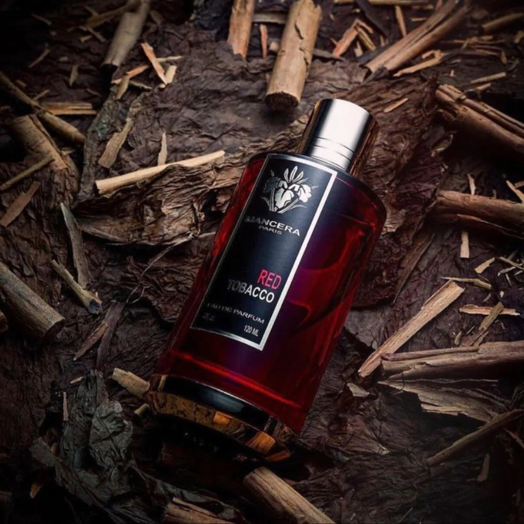 Mancera Red Tobacco Eau De Parfum 120ml bottle placed on dried wood chips, highlighting its rich woody and spicy scent profile.