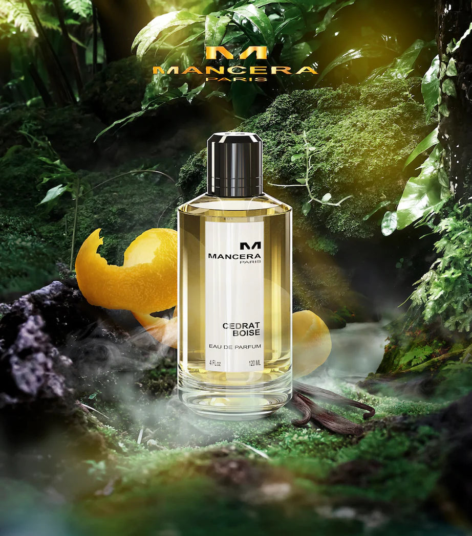 Mancera Cedrat Boise Eau de Parfum 120ml displayed in a lush forest setting with citrus peel, highlighting its fresh citrus aromatic notes.