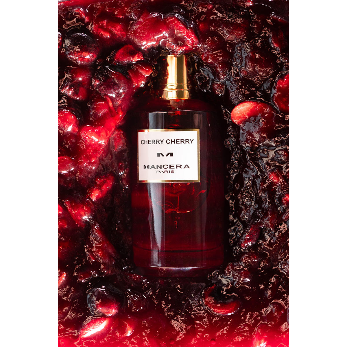 Mancera Cherry Cherry perfume bottle surrounded by rich cherry pulp, highlighting its fruity and woody spicy fragrance appeal.