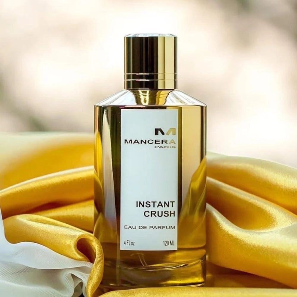 Instant Crush Perfume by Mancera displayed on golden satin fabric, highlighting its elegant design and Oriental Floral fragrance appeal.