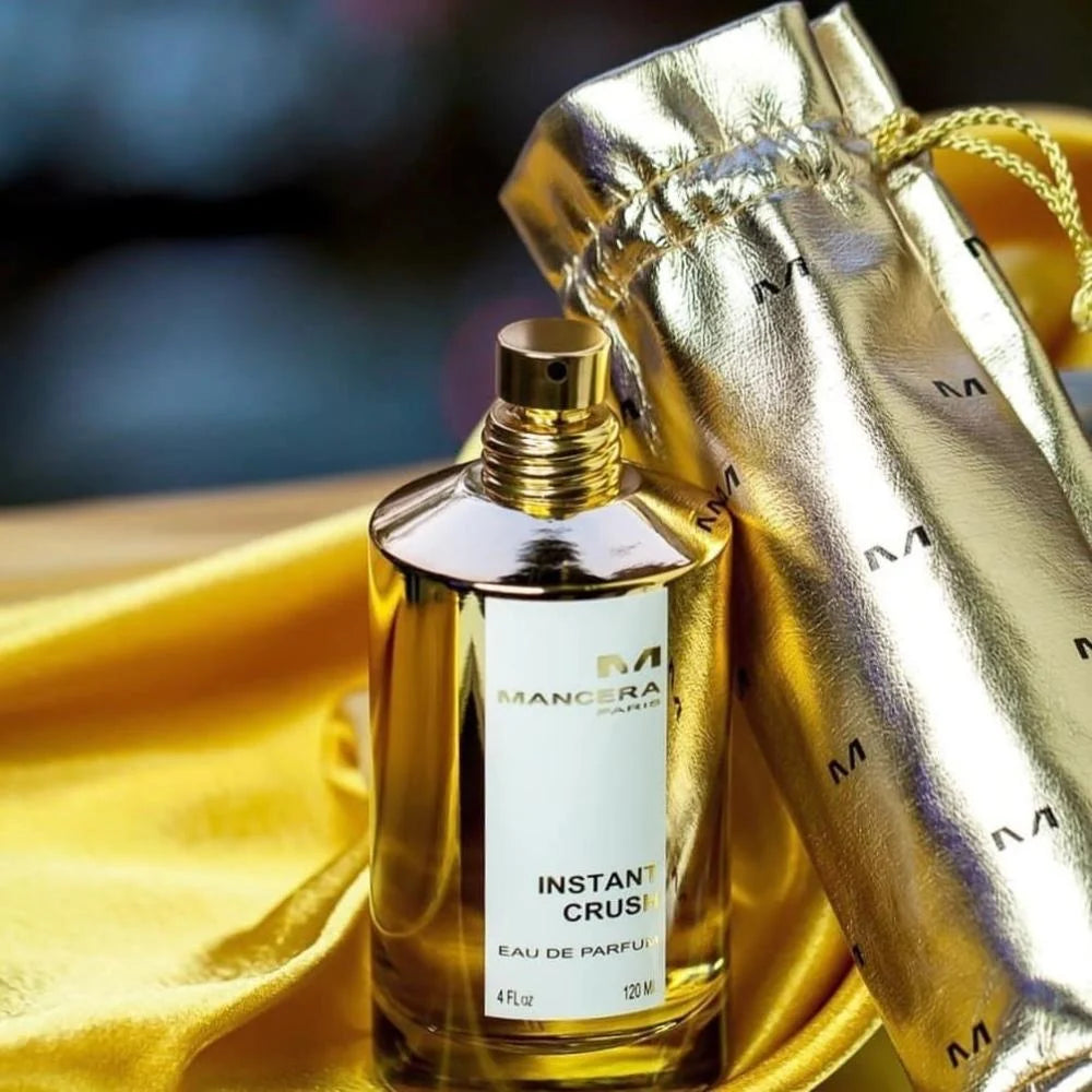 Mancera Instant Crush Perfume 120 ml with gold drawstring pouch on satin fabric, perfect for gifting luxury Oriental scents.
