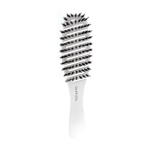 Olaplex Detangling Brush with curved vented design and soft bristles, perfect for reducing breakage and frizz on curly and elastic hair.