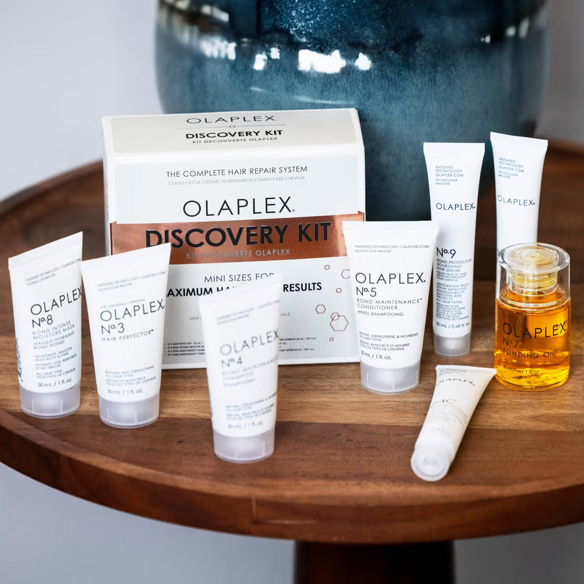 Olaplex Discovery Kit displayed on a wooden table, featuring full mini hair care range for all hair types and intensive repair.