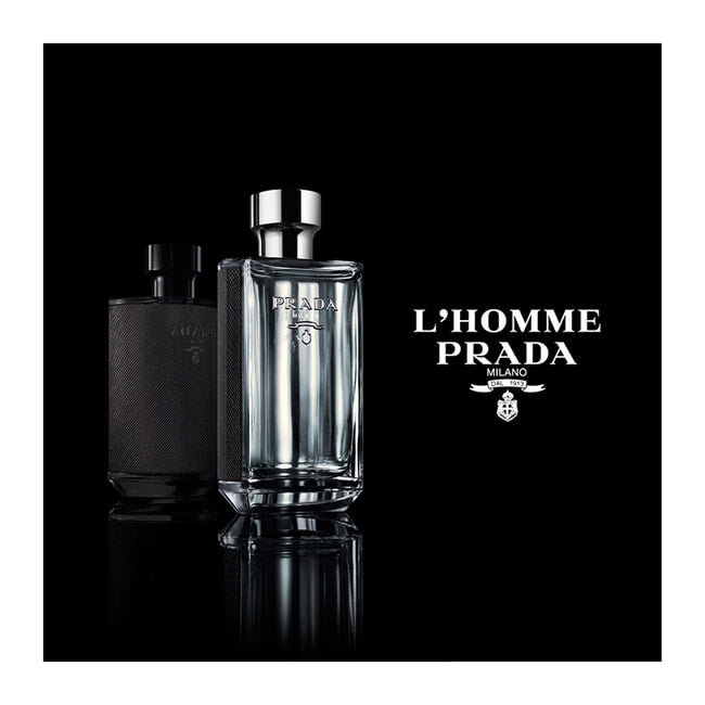 Prada L'Homme Eau De Toilette bottles displayed on black background, highlighting the luxury men's woody chypre fragrance.