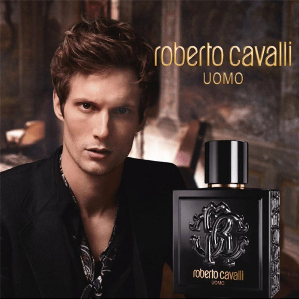 Roberto Cavalli UOMO EDT 100ml promotional image with male model and perfume bottle, showcasing the 2016 oriental scent for men.