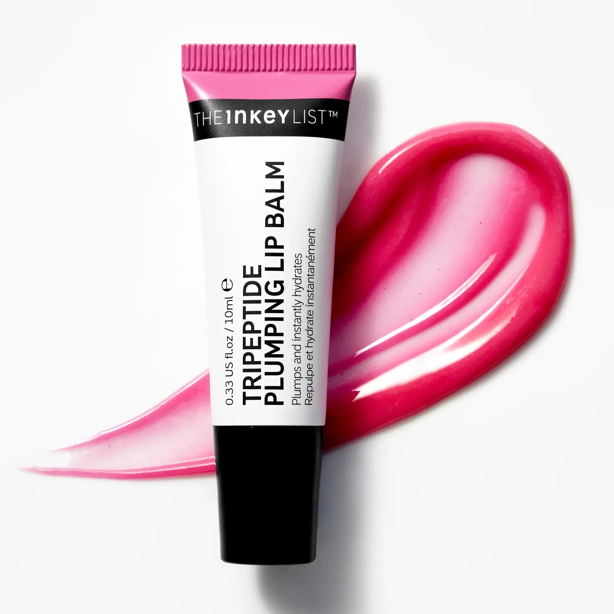 The Inkey List Tripeptide Plumping Lip Balm Pink Tint 10 ml tube on a pink balm smear. Hydrating formula enhances lip volume without irritation.