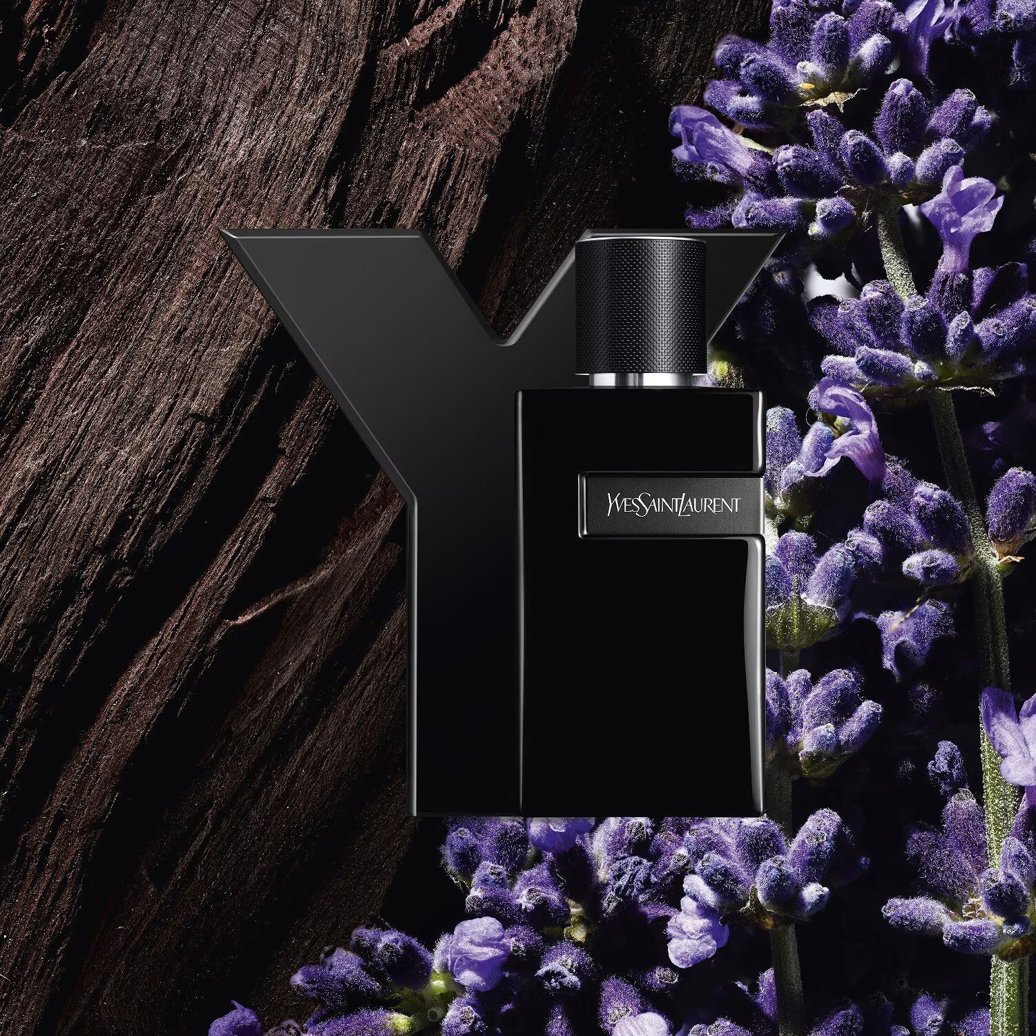 YSL Y Le Parfum bottle for men placed against lavender and wood textures, highlighting its fresh and intense Oriental Fougere scent.