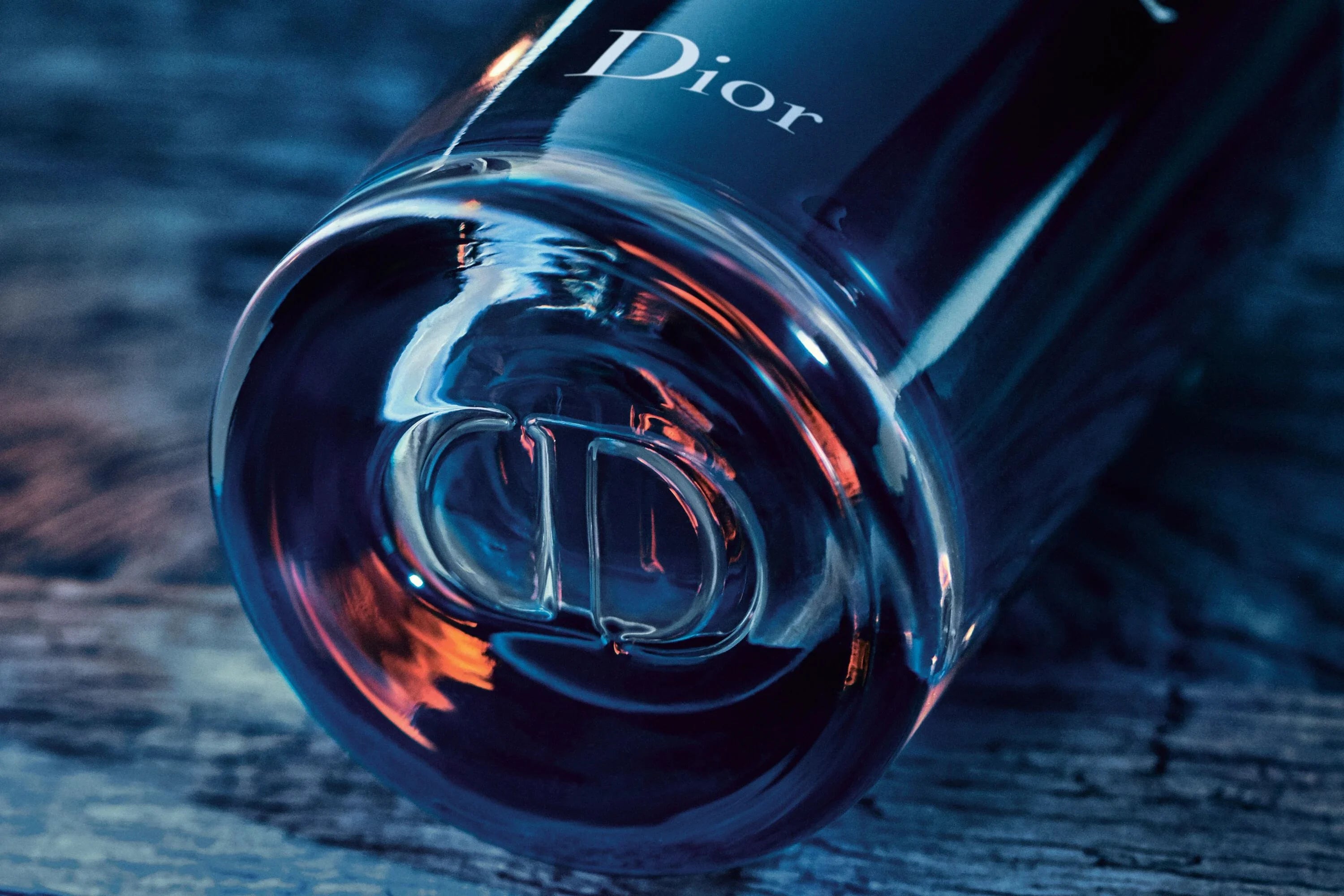 Close-up of Dior Sauvage Perfume - 100ml Eau de Parfum base with embossed CD logo, showcasing premium craftsmanship and branding.