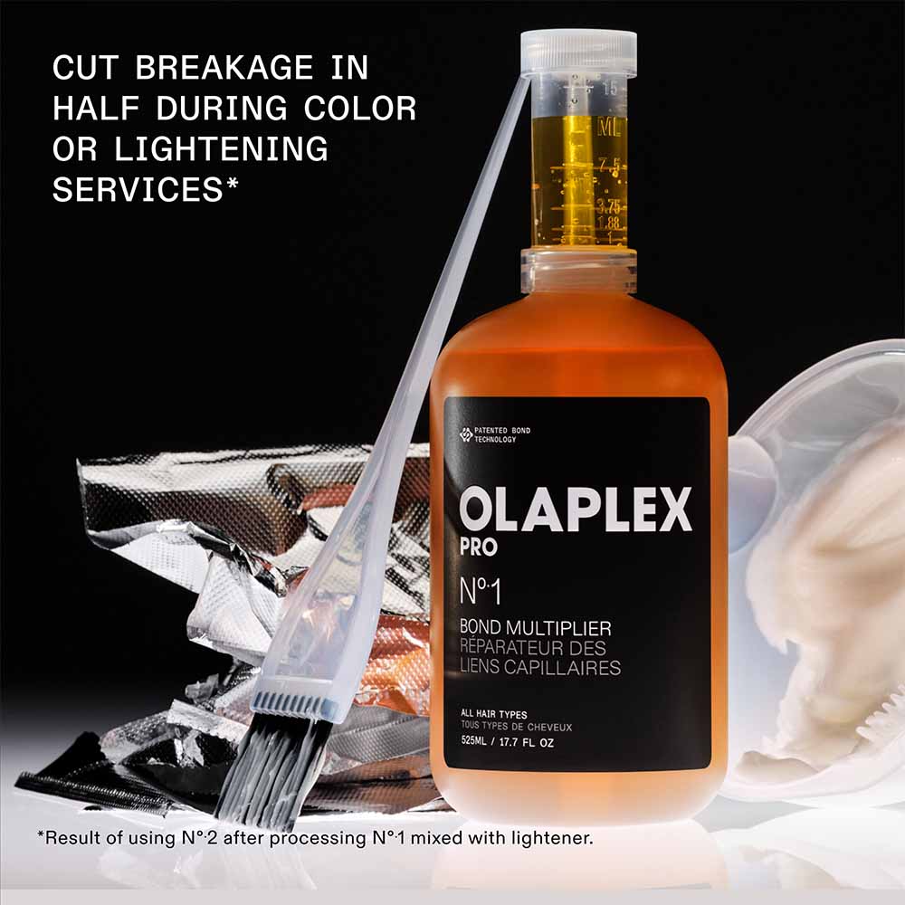 Olaplex Pro No.1 Bond Multiplier in a 525 ml bottle with black label, orange liquid, used for hair strengthening during chemical treatments.